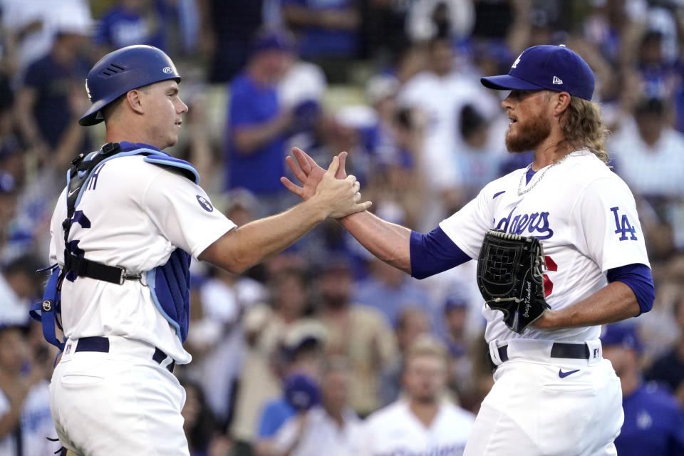 Los Angeles Dodgers catcher Will Smith, left, and relief pitcher Craig Kimbrel congratulate each other after the Dodgers defeated the San Diego Padres 4-0 in a baseball game Sunday, Aug. 7, 2022, in Los Angeles. (AP Photo/Mark J. Terrill)