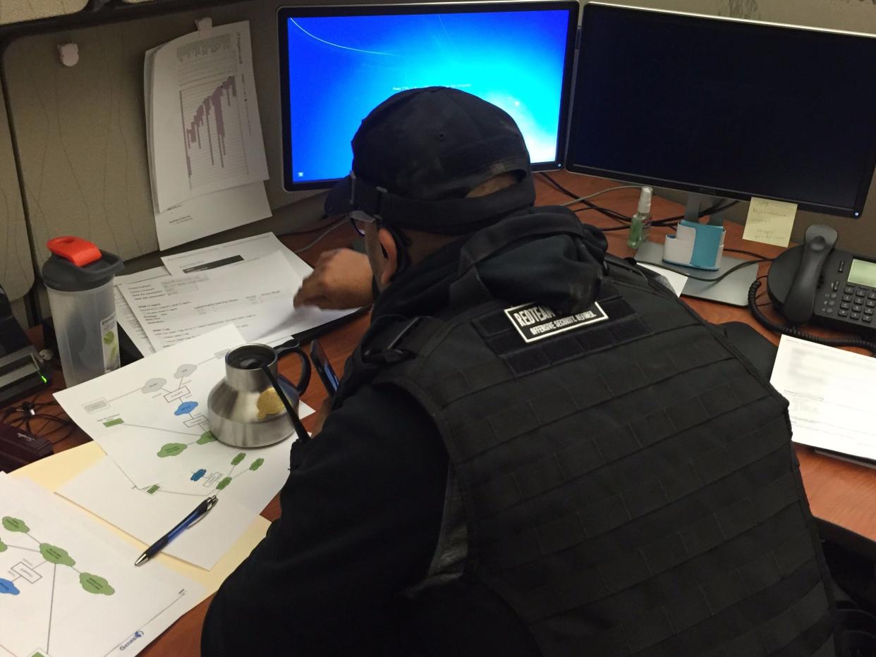 hacker looking through desk