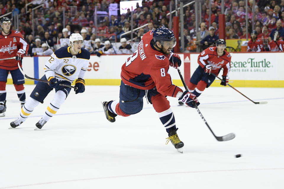 Washington Capitals left wing Alex Ovechkin (8), of Russia, shoots for a goal during the second period of an NHL hockey game in front of Buffalo Sabres right wing Tage Thompson (72), Saturday, Dec. 15, 2018, in Washington. (AP Photo/Nick Wass)