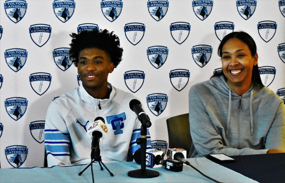 Tolton guard Aaron Rowe, left, and his mother Tina Rowe, right, patiently wait for Aaron's commitment ceremony to begin at Tolton Catholic High School on Dec. 12, 2023, in Columbia, Mo.