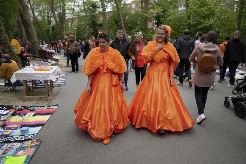 Orange-clad people celebrate King's Day in Amsterdam, Netherlands, Wednesday, April 27, 2022. After two years of celebrations muted by coronavirus lockdowns, the Netherlands marked the 55th anniversary of King Willem-Alexander of the House of Orange with street parties, music festivals and a national poll showing trust in the monarch ebbing away. (AP Photo/Peter Dejong)