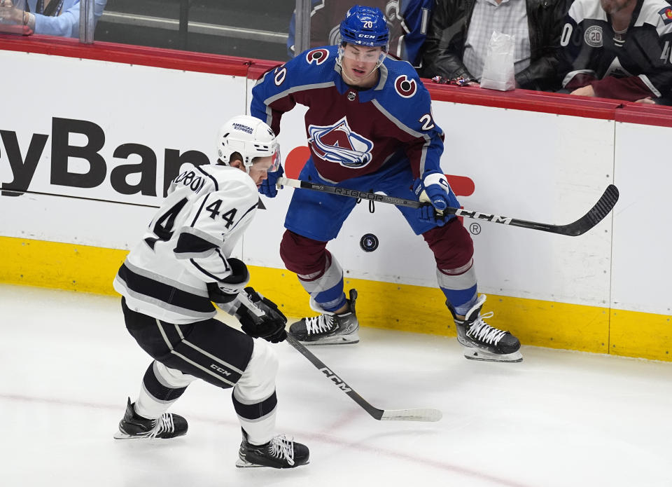 Los Angeles Kings defenseman Mikey Anderson, front, loses control of the puck as Colorado Avalanche center Ross Colton watches during the first period of an NHL hockey game Friday, Jan. 26, 2024, in Denver. (AP Photo/David Zalubowski)