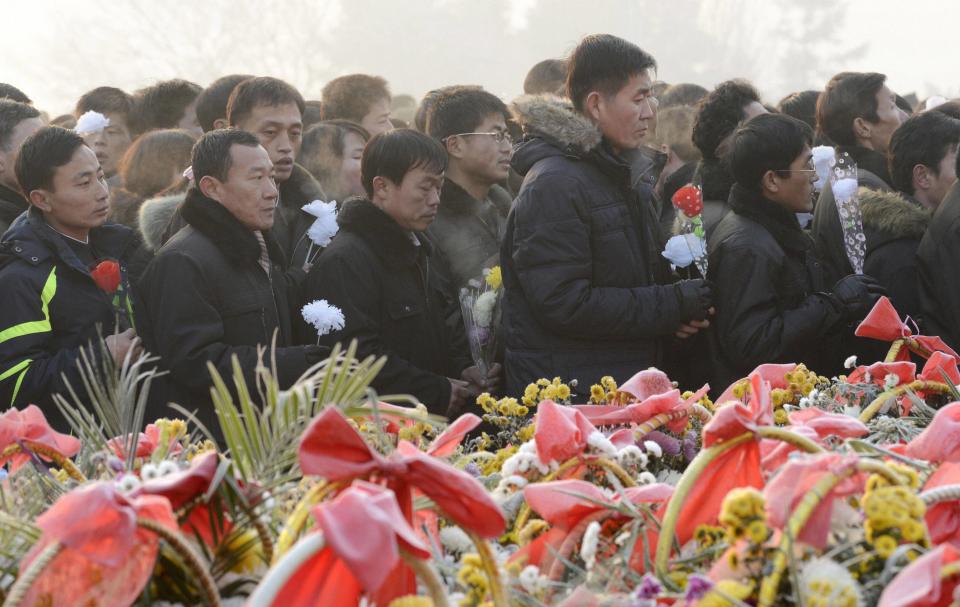 North Koreans offer flowers to bronze statues (not pictured) of North Korea's late founder Kim Il Sung and late leader Kim Jong Il at Mansudae in Pyongyang, in this picture taken and provided by Kyodo December 17, 2013, to mark the second death anniversary of Kim Jong Il. (REUTERS/Kyodo)