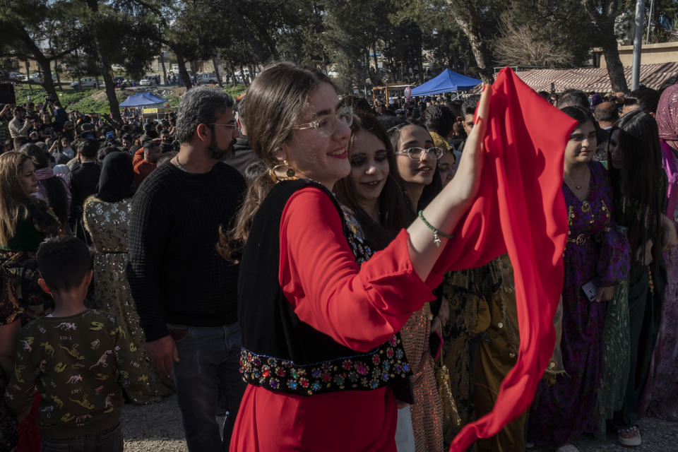 Iraqi Kurds celebrate Nowruz, a Persian New Year, in Sulaimaniyah, Iraq, Monday, March 20, 2023. The Kurdish in Iraq region won de facto self-rule in 1991 when the United States imposed a no-fly zone over it in response to Saddam's brutal repression of Kurdish uprisings. With American invasion 20 years ago much of Iraq fell into chaos, as occupying American forces fought an insurgency and as multiple political and sectarian communities vied to fill the power vacuum left in Baghdad. But the Kurds, seen as staunch allies of the Americans, strengthened their political position and courted foreign investments. (AP Photo/Hawre Khalid, Metrography)