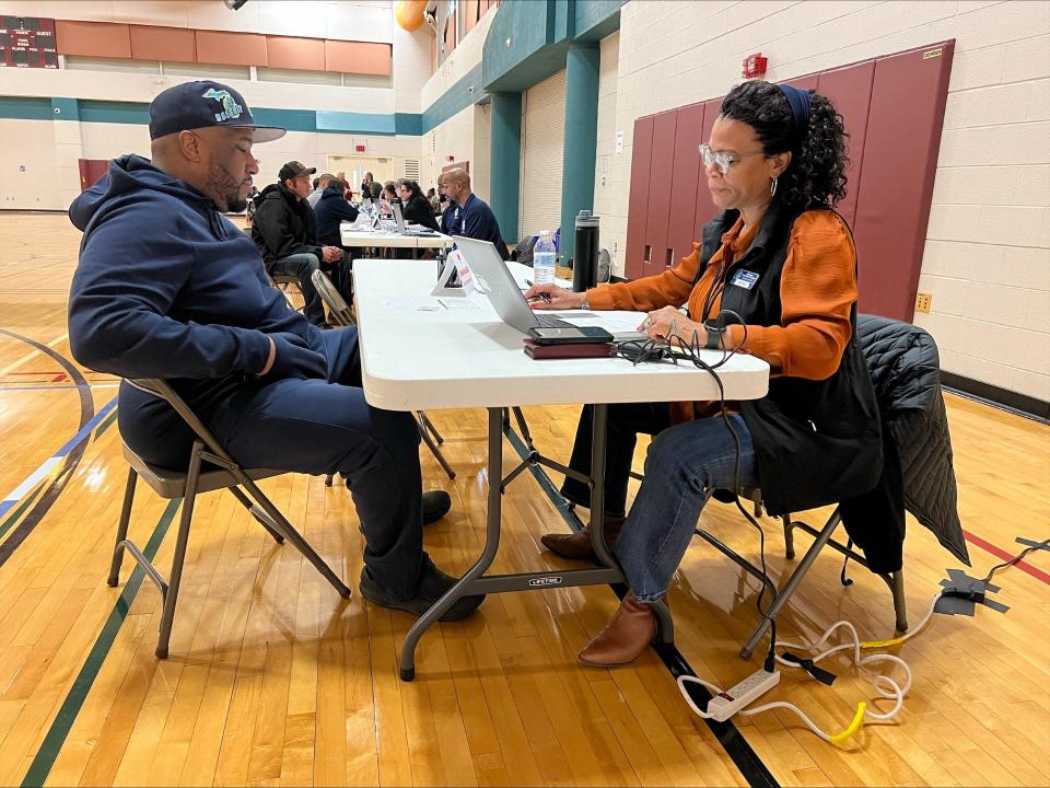 Keitha Cameron (right) from the Michigan Department of State helped an attendee at Tuesday's Road to Restoration driver license restoration clinic at Monroe County Community College. Ninety-six people attended.