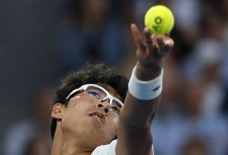 Tennis - Australian Open - Rod Laver Arena, Melbourne, Australia, January 22, 2018. Chung Hyeon of South Korea serves against Novak Djokovic of Serbia. REUTERS/Issei Kato