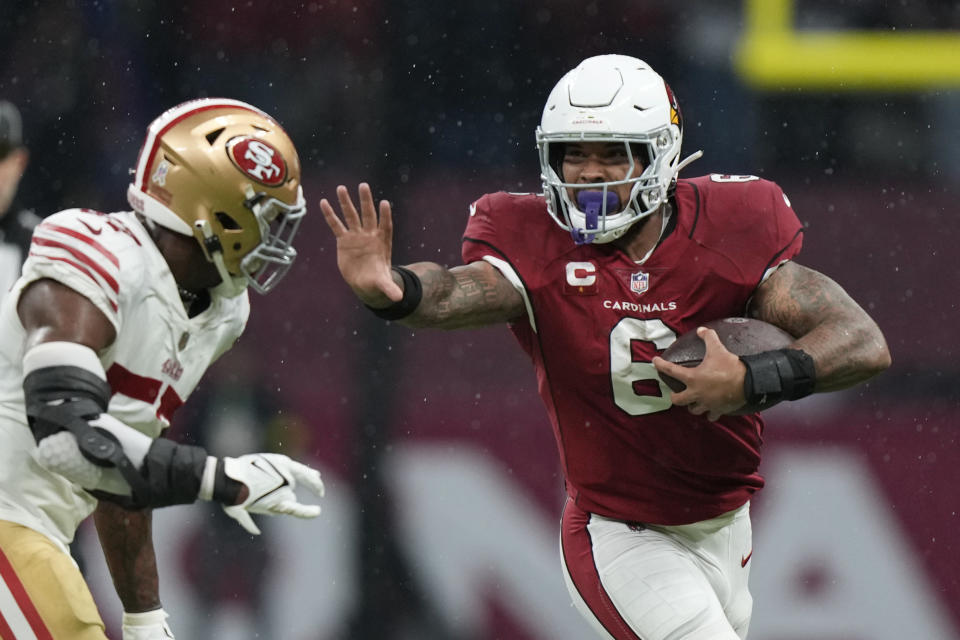 Arizona Cardinals running back James Conner, right, runs with the ball as San Francisco 49ers linebacker Dre Greenlaw defends during the first half of an NFL football game Monday, Nov. 21, 2022, in Mexico City. (AP Photo/Fernando Llano)