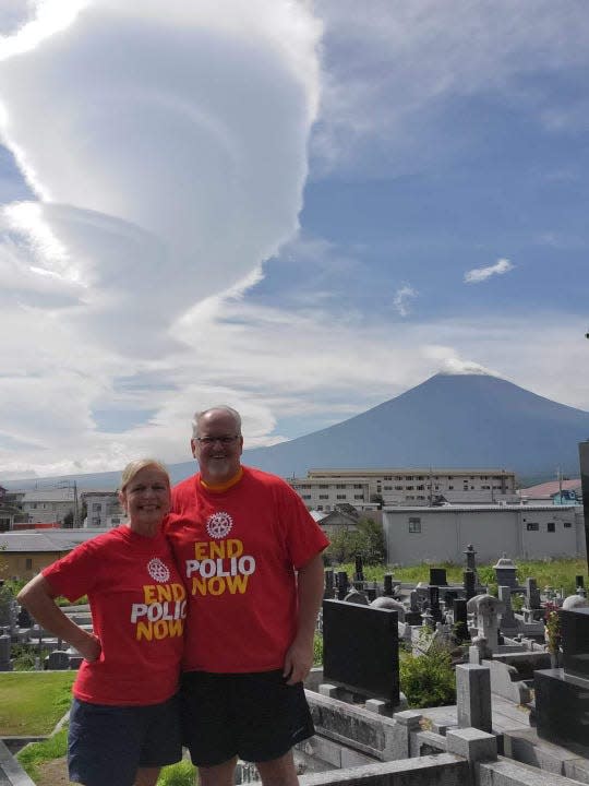 Jimmy Hill and Jannah Bailey stand in front of Mt. Fuji in Tokyo.