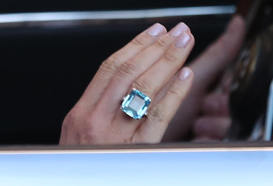 Meghan showed off the ring as she waved to onlookers. [Photo: PA]