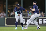 Seattle Mariners center fielder Julio Rodríguez, left, and right fielder Mitch Haniger, right, collide on an RBI sacrifice fly by Houston Astros' Mauricio Dubón during the seventh inning of a baseball game Friday, May 3, 2024, in Houston. (AP Photo/Kevin M. Cox)