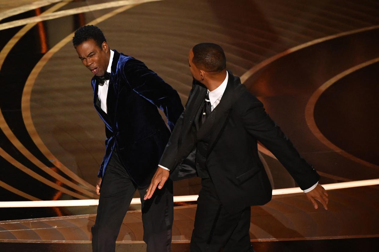 US actor Will Smith (R) slaps US actor Chris Rock onstage during the 94th Oscars at the Dolby Theatre in Hollywood, California on March 27, 2022. (Photo by Robyn Beck / AFP) (Photo by ROBYN BECK/AFP via Getty Images)