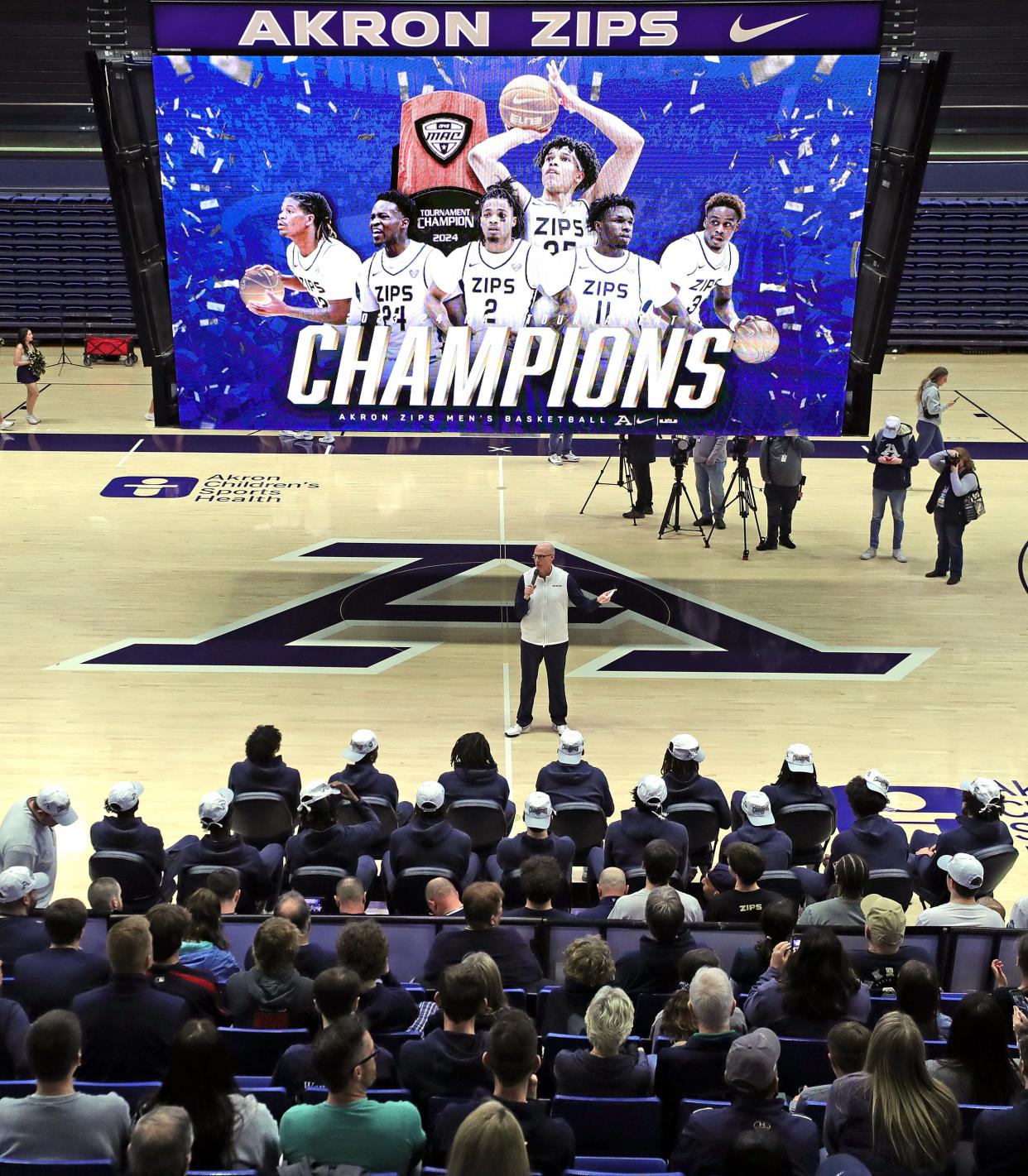 Akron coach John Groce speaks to his team and a small group of fans during the Zips' watch party for the NCAA Tournament Selection Show on Sunday in Akron.