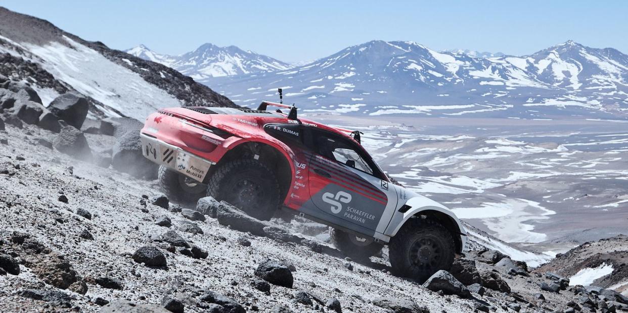 lifted porsche 911 prototype driving on the side of a volcano