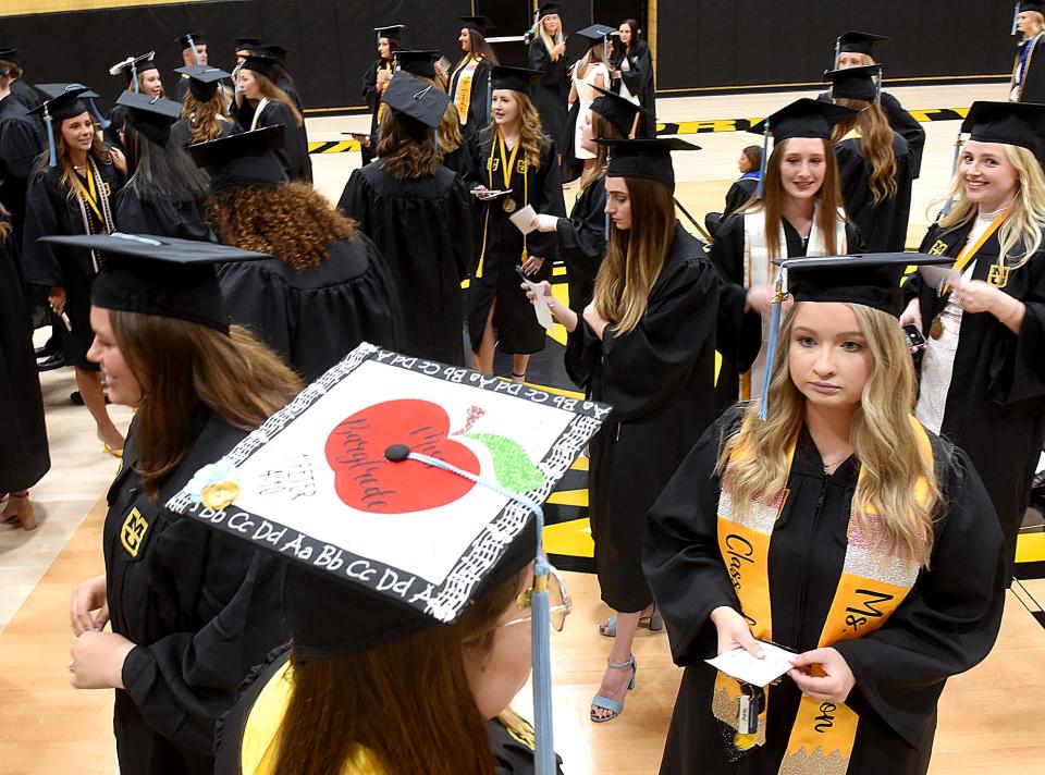 Hannah Bargfrede of Alma decorated her mortar board with ABCs for graduation on Friday at Mizzou Arena with a degree in elementary education. At right is Jenna Gibson of Henry, Ill.