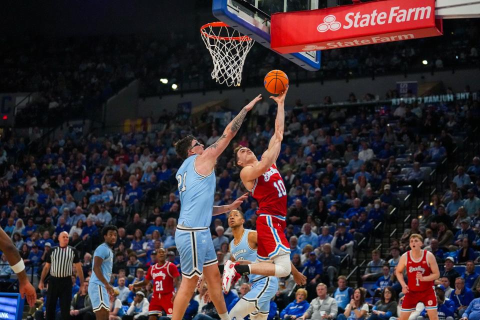 Bradley Braves guard Connor Hickman drives past Indiana State center Robbie Avila during BU's 95-86 overtime loss at Hulman Center on Saturday, Jan. 27, 2024.