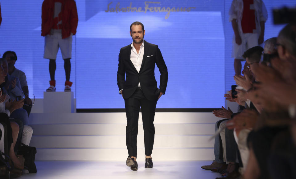 Creative director Massimiliano Giornetti takes the catwalk at the end of the Salvatore Ferragamo men's Spring-Summer 2014 fashion show, part of the Milan Fashion Week, unveiled in Milan, Italy, Sunday, June 23, 2013. (AP Photo/Luca Bruno)