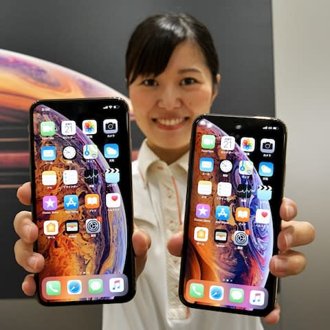 A model poses for camera during a launch day for Apple New iPhone Xs and Xs Max at the KDDI's au Shinjuku store in Tokyo, Japan