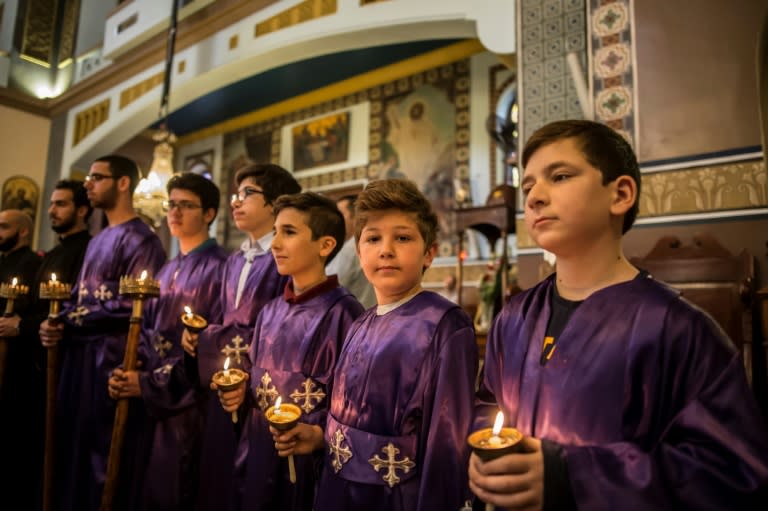 Egyptian Christians take part in the Good Friday procession at the Arch Angels Greek Orthodox Church in the capital Cairo, on April 14, 2017