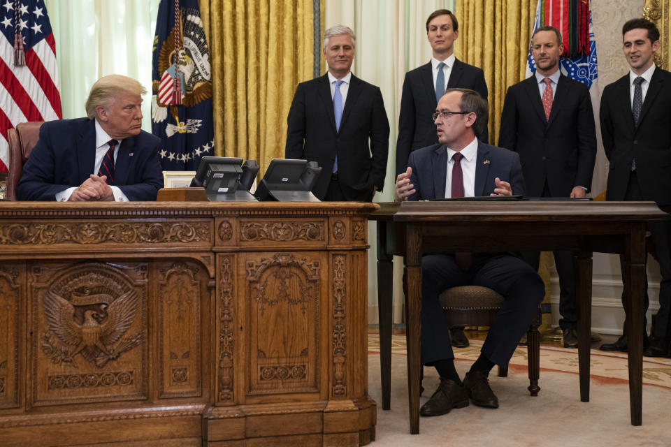 President Donald Trump listens to Kosovar Prime Minister Avdullah Hoti during a signing ceremony with Serbian President Aleksandar Vucic, in the Oval Office of the White House, Friday, Sept. 4, 2020, in Washington. (AP Photo/Evan Vucci)