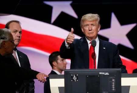 Trump gives a thumbs up as campaign official Rick Gates (2ndL) looks on during Trump's walk through at the Republican National Convention in Cleveland, July 2016. REUTERS/Rick Wilking