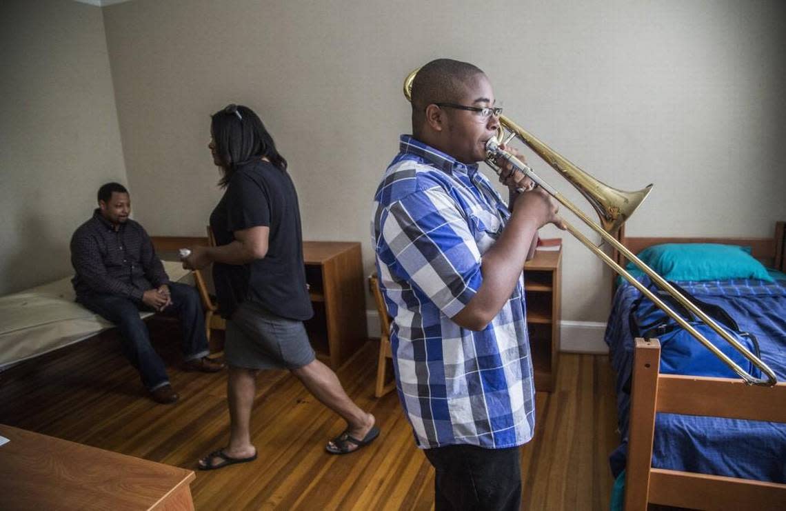 Justin Hardy, 17, right, practices his trombone while receiving help from his parents Jimeese and Brian Hardy while moving into a dormitory during a Governor’s School orientation Sunday, June 18, 2017, at Meredith College in Raleigh.