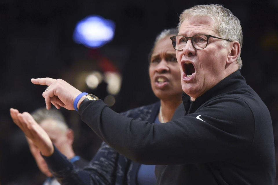 UConn assistant coach Jamelle Elliott, left, and head coach Geno Auriemma, right, react to a call during the first half of an Elite Eight college basketball game against Southern California in the women's NCAA Tournament, Monday, April 1, 2024, in Portland, Ore. (AP Photo/Steve Dykes)