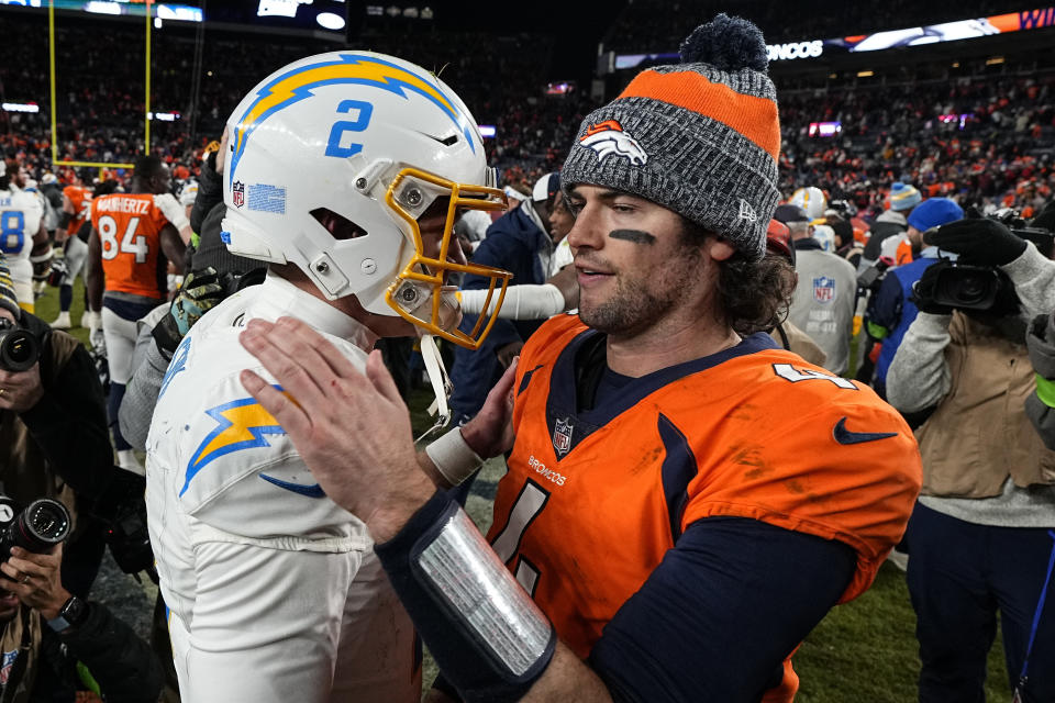 Los Angeles Chargers quarterback Easton Stick (2) and Los Angeles Chargers quarterback Will Grier (4) speak midfield after an NFL football game, Sunday, Dec. 31, 2023, in Denver. The Denver Broncos won 16-9. (AP Photo/Jack Dempsey)