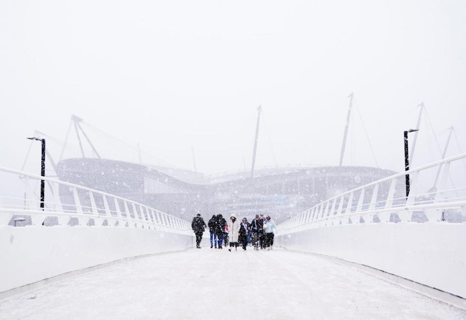 The approach to Manchester City’s Etihad Stadium was shrouded in snow (Martin Rickett/PA) (PA Wire)