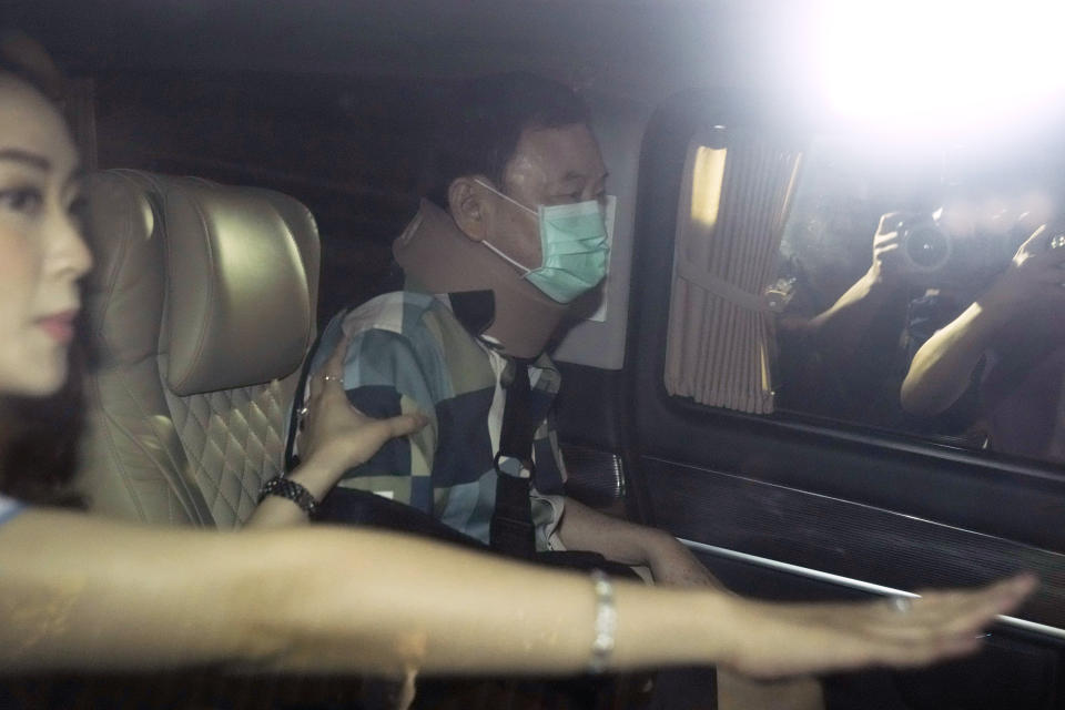 Former Thai Prime Minister Thaksin Shinawatra, center, sits in a vehicle with his daughters Paetongtarn and Pinthongta after being released on parole Sunday, Feb. 18, 2024, in Bangkok, Thailand. Thaksin was released from Police General Hospital where for the last six months he had been serving time for corruption-related offenses. (AP Photo/Sakchai Lalit)