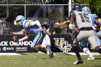 Tulane quarterback Michael Pratt, left, scrambles from the pocket as he is pressured by Central Florida linebacker Tatum Bethune (15) during the first half of an NCAA college football game, Saturday, Oct. 24, 2020, in Orlando, Fla. (AP Photo/John Raoux)