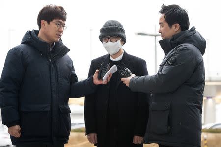 A passenger who launched a lengthy, violent scuffle on board a Korean Air flight from Vietnam to South Korea last week arrives at the Incheon International Airport Police in Incheon, South Korea, December 26, 2016. Yoo Seung-kwan/News1 via REUTERS