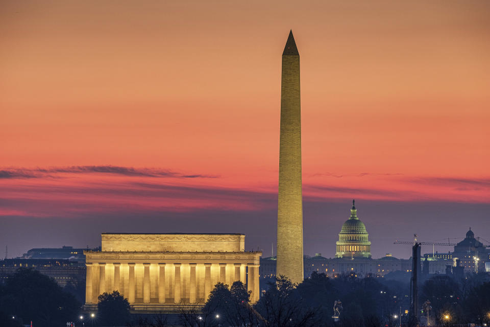 FILE - In this Feb. 17, 2020, file photo, the Lincoln Memorial, left, and the Washington Monument, center, are seen in the early morning light in Washington. The U.S. Capitol building is in the background right. For a majority of Democratic voters, going back to the days before Donald Trump isn’t good enough. (AP Photo/J. David Ake, File)