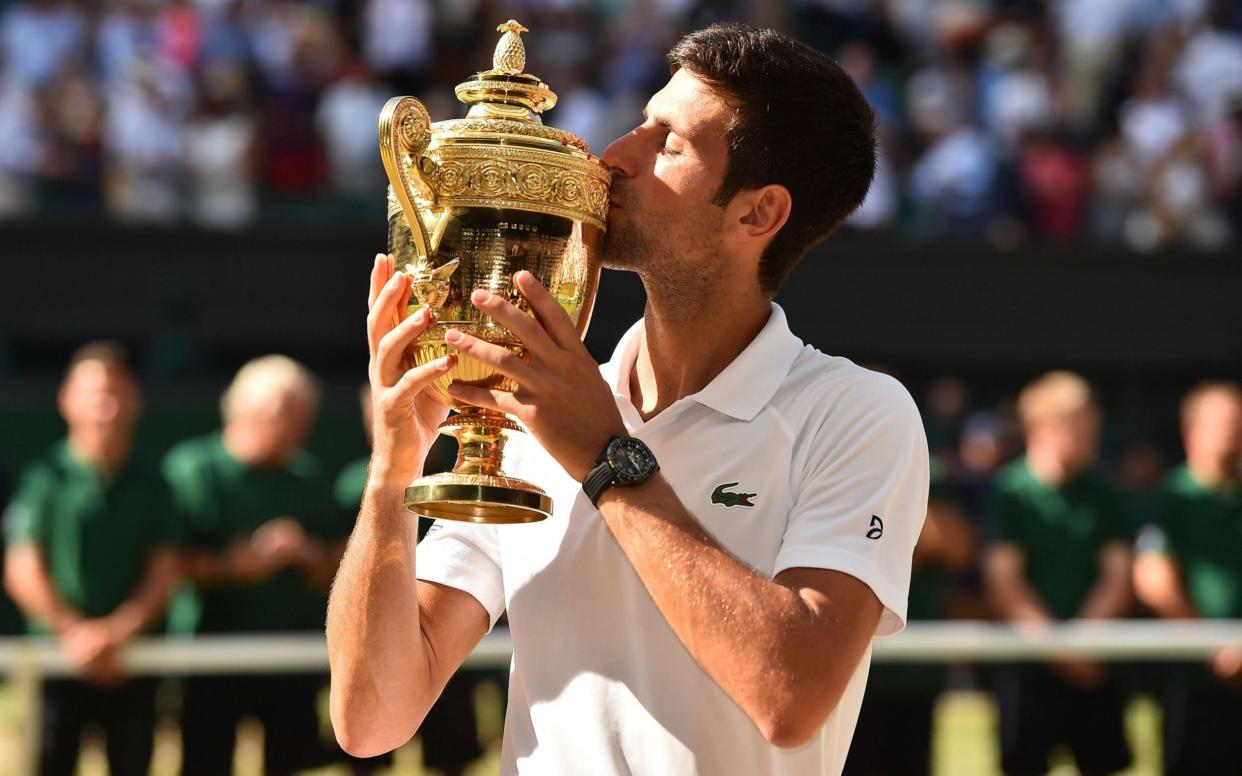 Novak Djokovic kisses the winners trophy after beating South Africa's Kevin Anderson - AFP