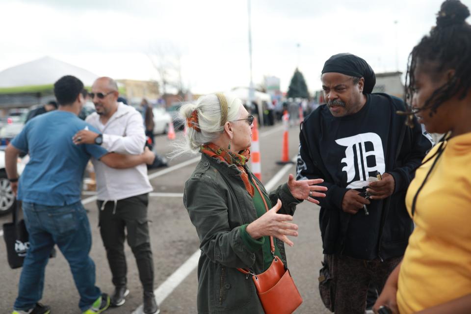 Hamtramck Mayor Karen Majewski, center, talks with residents about finding lead in tap water Thursday at the Town Center, where free water filters were handed out to Hamtramck residents.