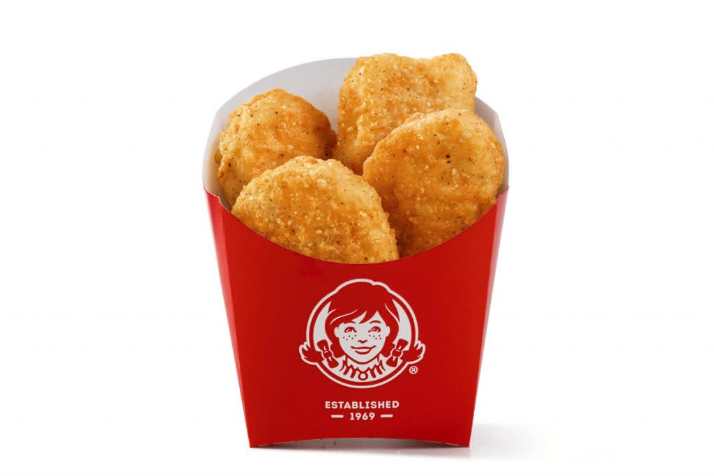 A four-piece chicken nugget meal is photographed. 