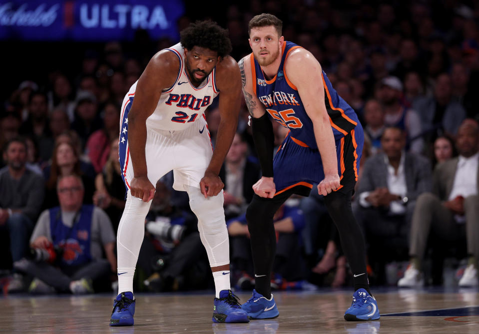 NEW YORK, NEW YORK - APRIL 30: Joel Embiid #21 of the Philadelphia 76ers and Isaiah Hartenstein #55 of the New York Knicks line up next to each other during the second half at Madison Square Garden on April 30, 2024 in New York City. The Philadelphia 76ers defeated the New York Knicks 112-106 in overtime. NOTE TO USER: User expressly acknowledges and agrees that, by downloading and or using this photograph, User is consenting to the terms and conditions of the Getty Images License Agreement. (Photo by Elsa/Getty Images)