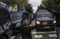 <p>People try to stop Spanish police vans outside the Ramon Llull polling station in Barcelona Oct. 1, 2017 during a referendum on independence for Catalonia banned by Madrid. (Photo: Fabio Bucciarelli/AFP/Getty Images) </p>