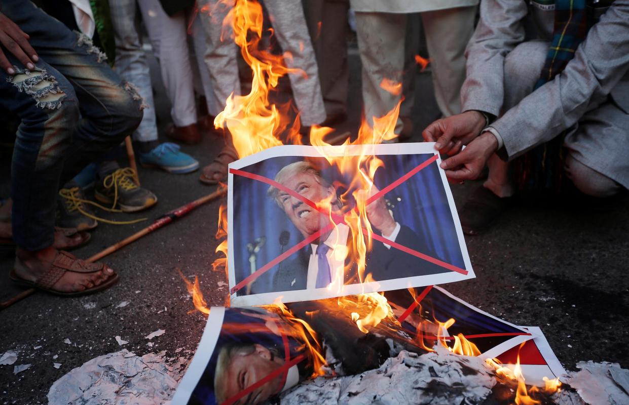 Protesters burn posters of US President Donald Trump during a protest against the US decision to recognise Jerusalem as the capital of Israel: Reuters