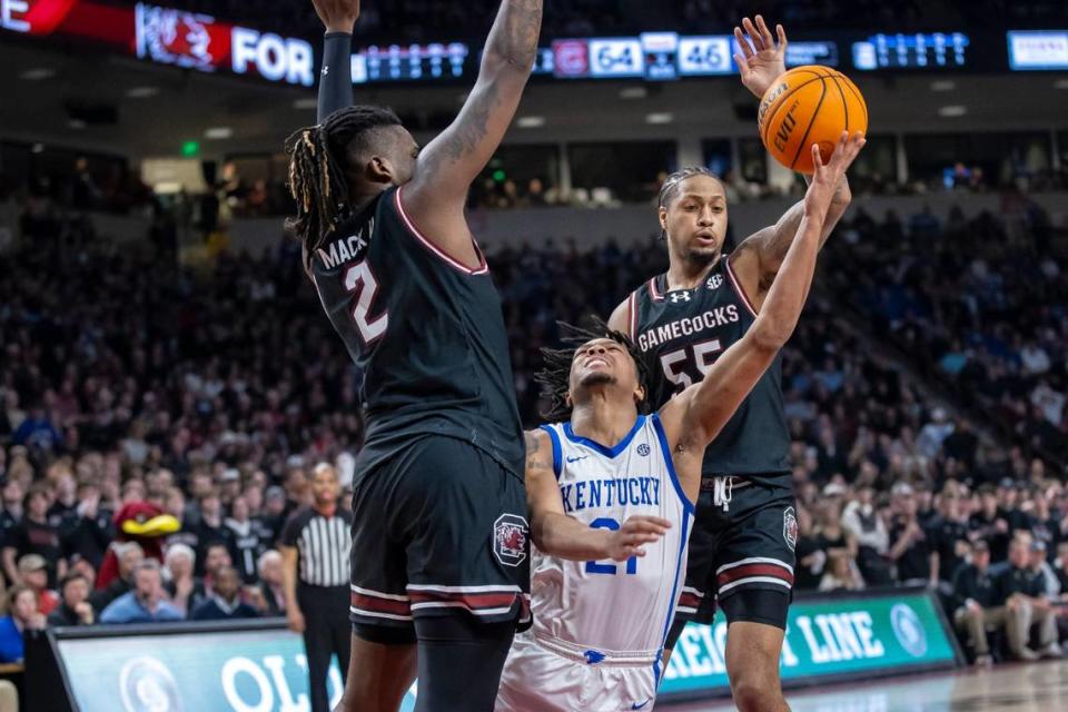 Kentucky’s D.J. Wagner (21) tries to find room for a shot between South Carolina’s B.J. Mack (2) and Ta’Lon Cooper (55) on Tuesday night. The Wildcats made just 40.3 percent of their shots from the field and 30.8 percent of their three-point attempts.