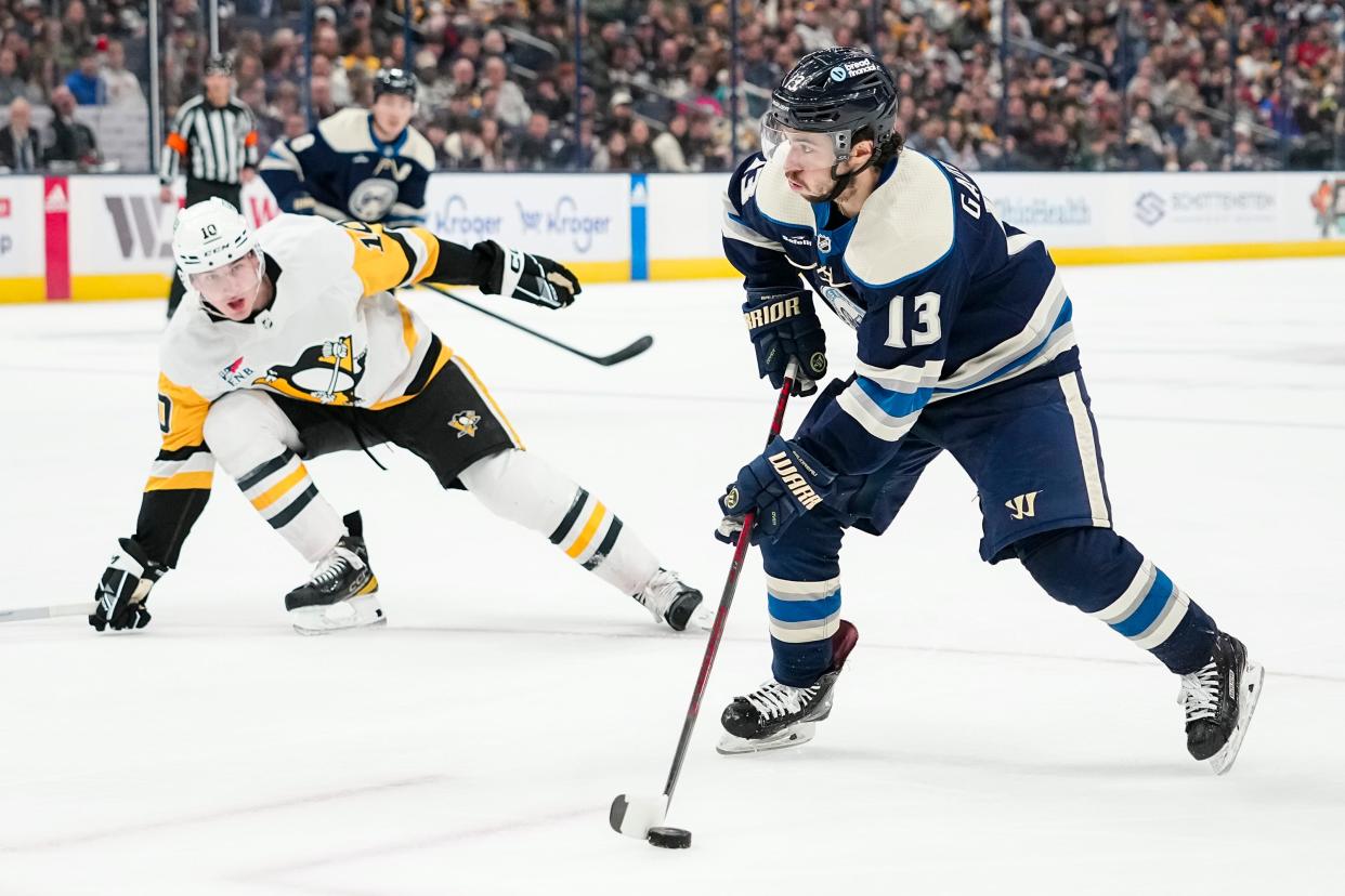 Mar 30, 2024; Columbus, Ohio, USA; Columbus Blue Jackets left wing Johnny Gaudreau (13) skates around Pittsburgh Penguins left wing Drew O'Connor (10) during the first period of the NHL hockey game at Nationwide Arena.