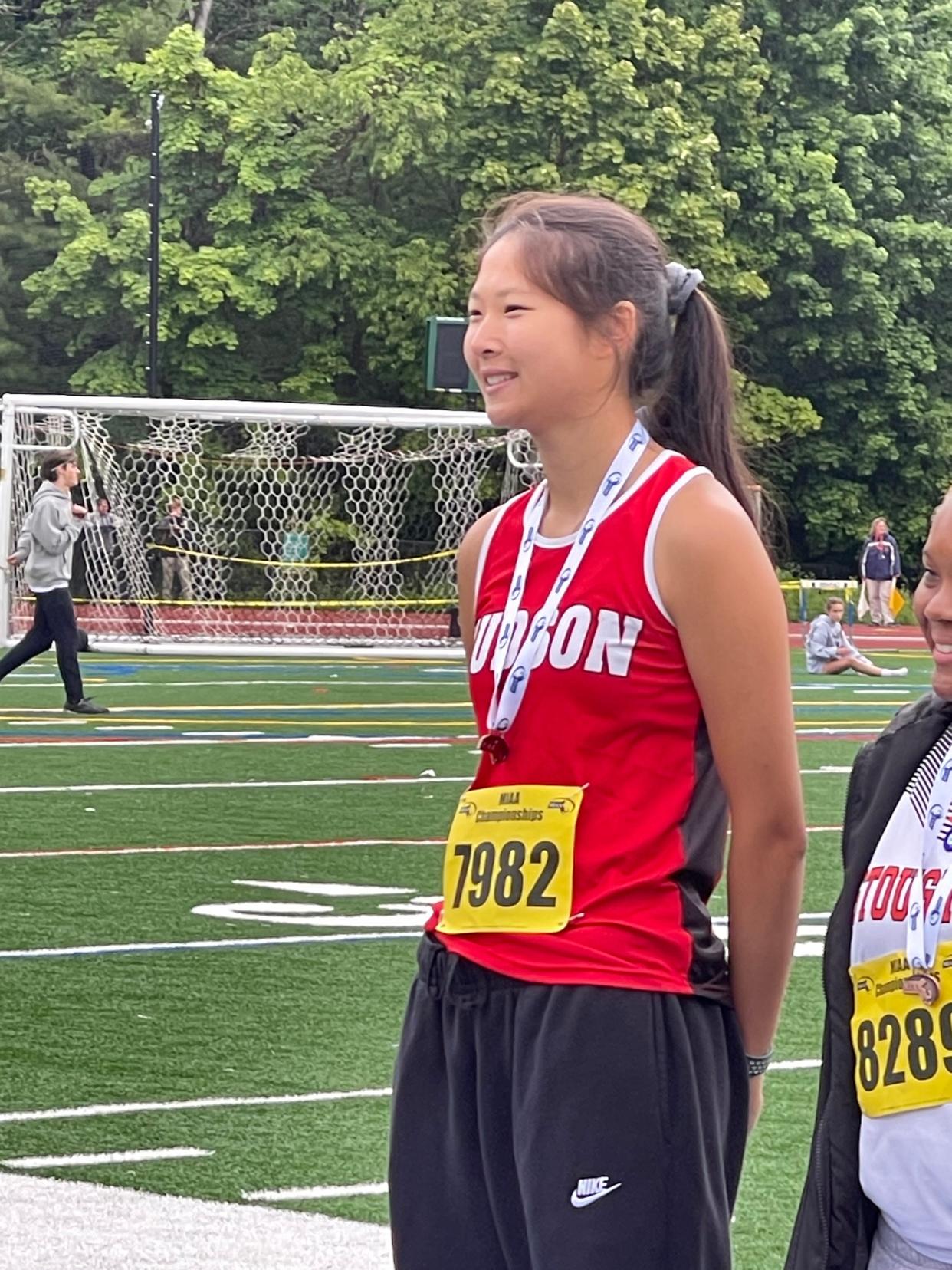 Hudson’s Savannah Gao displays the third-place javelin medal she won at Saturday’s Meet of Champions in Fitchburg.