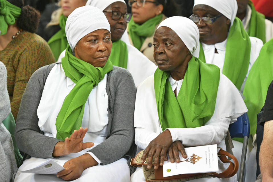 Members of the congregation wearing green as a symbol of remembrance, during a service of remembrance at St Helen's church to mark the two-year anniversary of the Grenfell Tower apartment block fire, near to the site of the fire in London, Friday June 14, 2019. Two years after the 24-storey tower-block fire that killed 72 people, campaigners say hundreds of apartment buildings remain at risk of a similar blaze. (Dominic Lipinski/PA via AP)