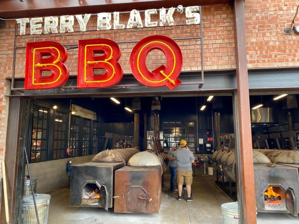 Fire pits welcome the patrons at Terry Black’s Barbecue.