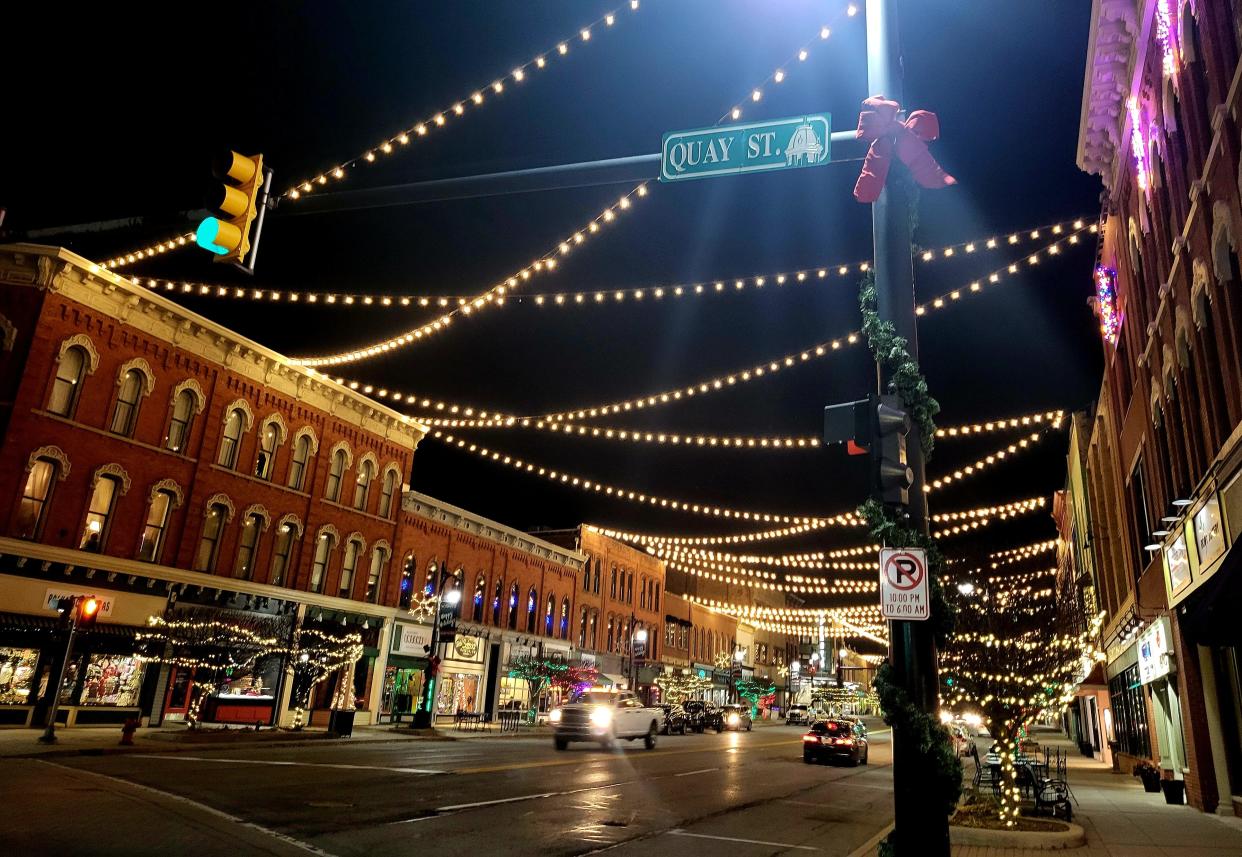 Street and building lights illuminate downtown Port Huron's Main Street at the corner with Quay Street on Thursday, Dec. 7, 2023.