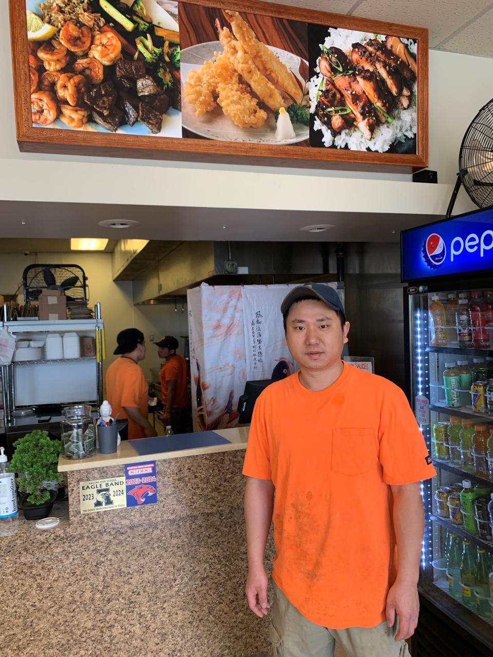 Ji Ni, owner of Little Ninja, stands inside his mostly empty restaurant at lunchtime Wednesday, as construction continues on Buffalo Gap Road.