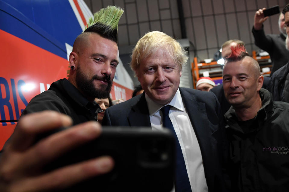 Prime Minister Boris Johnson poses for photos with members during a rally held at property marketing agency, Think BDW, Colchester, while on the General Election campaign trail.