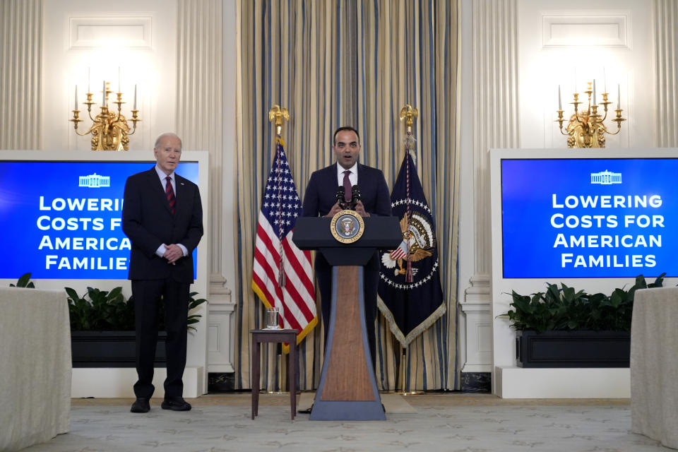 Rohit Chopra, director of the Consumer Financial Protection Bureau, speaks as President Joe Biden, left, looks on during a meeting with Biden's Competition Council to announce new actions to lower costs for families in the State Dining Room of the White House in Washington, Tuesday, March 5, 2024. (Credit: Andrew Harnik, AP Photo)
