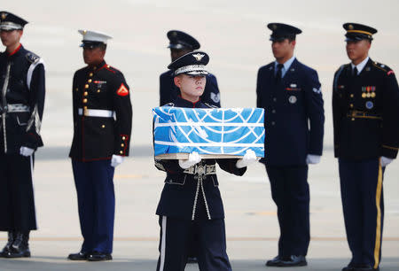 A soldier carries a casket containing the remains of a U.S. soldier who was killed in the Korean War during a ceremony at Osan Air Base in Pyeongtaek, South Korea, July 27, 2018. REUTERS/Kim Hong-Ji/Pool
