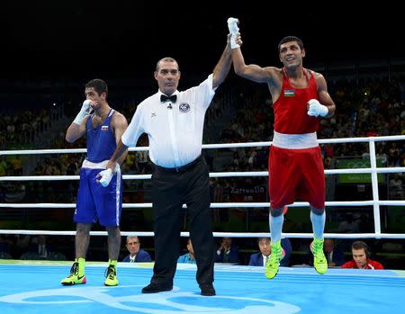 2016 Rio Olympics - Boxing - Final - Men's Fly (52kg) Final Bout 271 - Riocentro - Pavilion 6 - Rio de Janeiro, Brazil - 21/08/2016. Shakhobidin Zoirov (UZB) of Uzbekistan celebrates after winning his bout against Misha Aloian (RUS) of Russia. REUTERS/Peter Cziborra