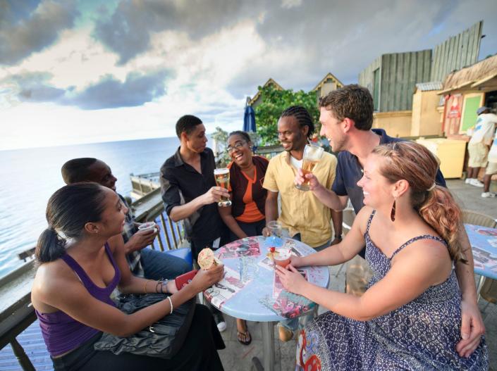 A group of people sitting around a table drinking at a Margaritaville Bar